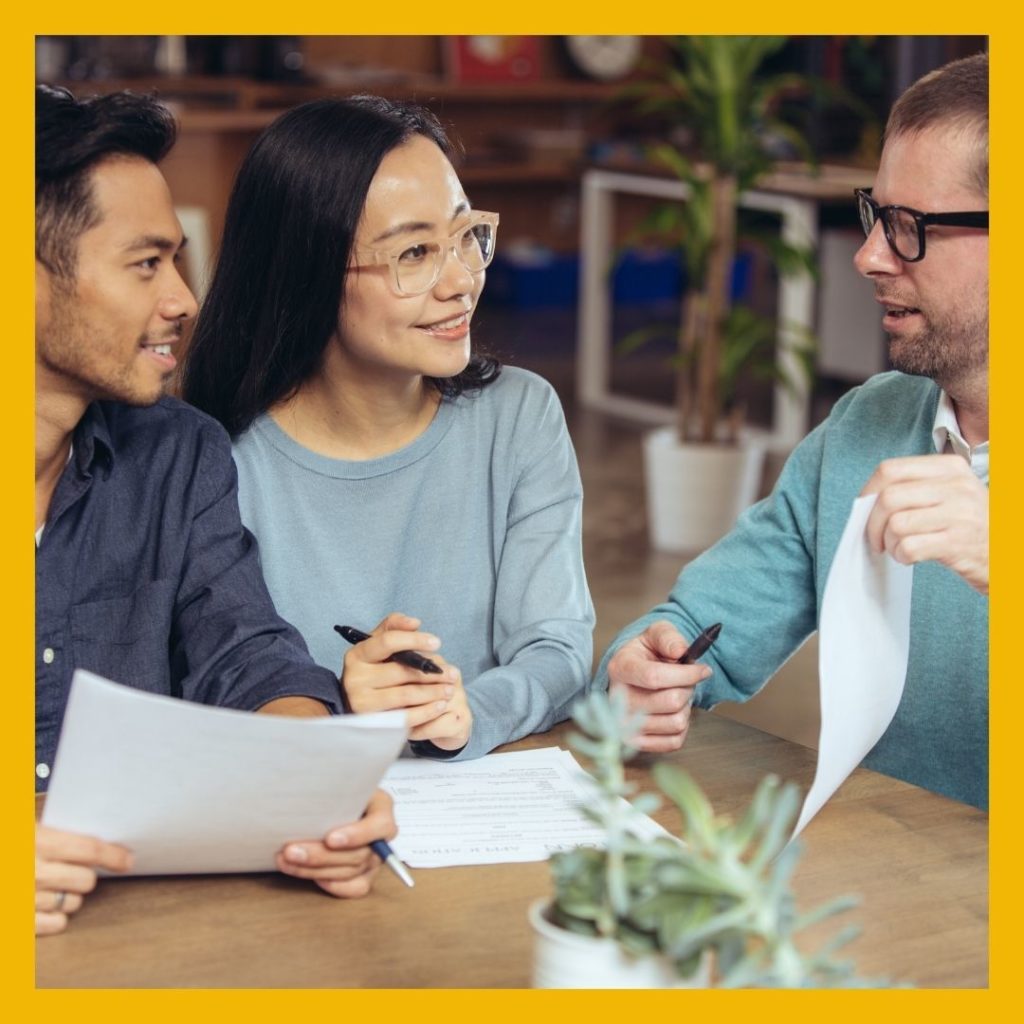 Smiling business professionals reviewing paperwork